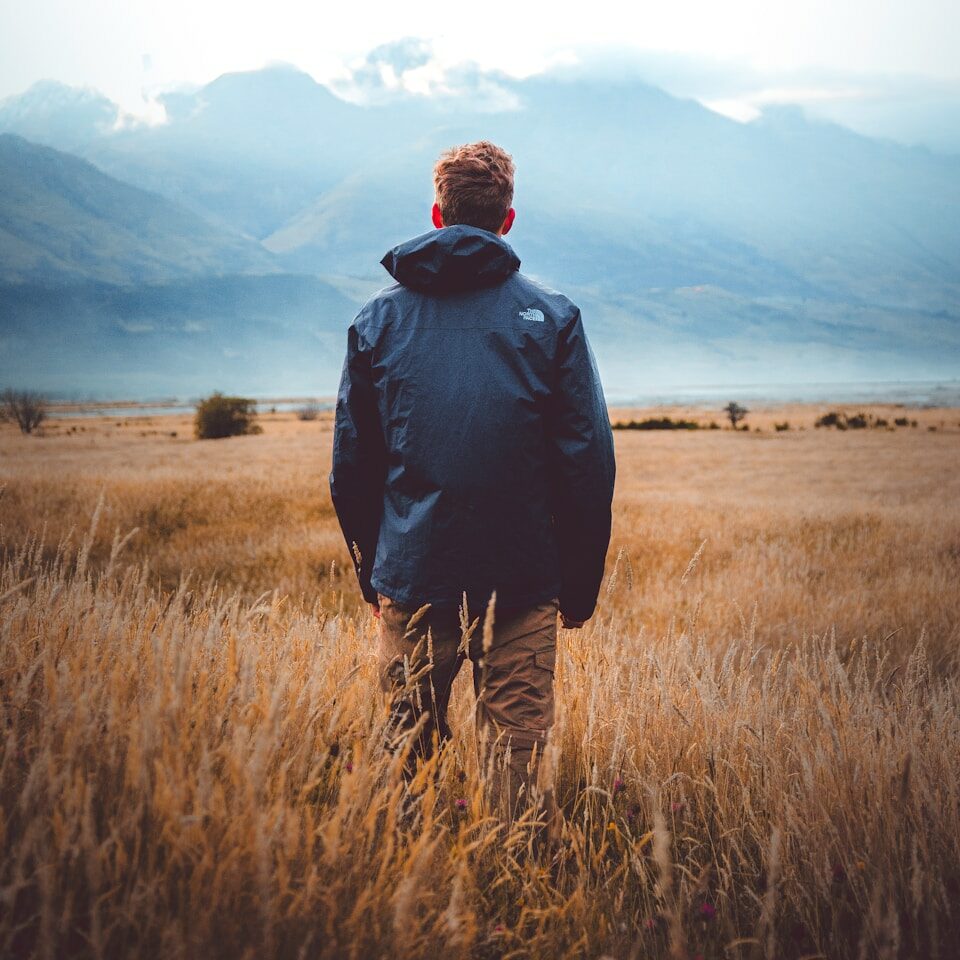 man in middle of wheat field